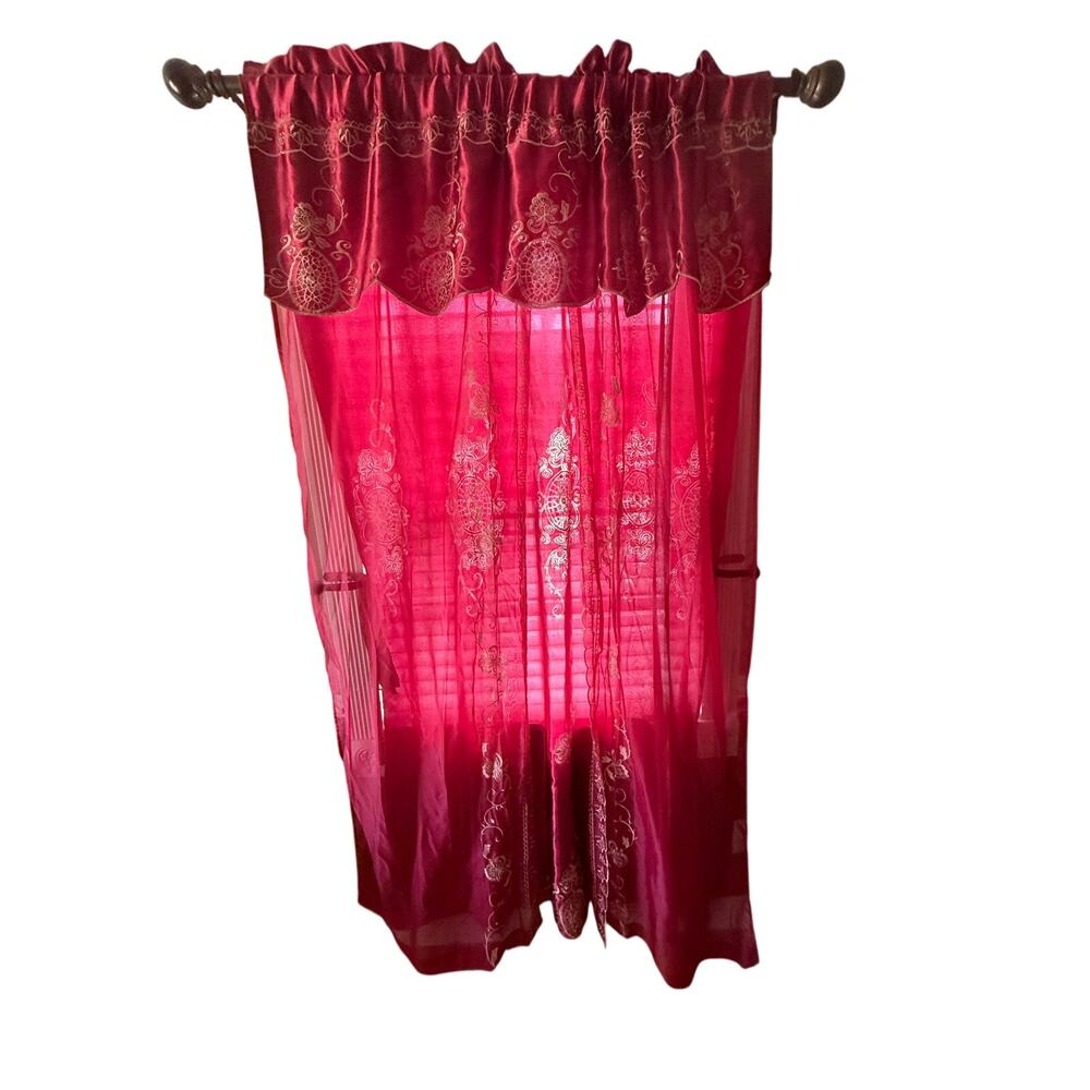 Red embroidered curtain valance at the top and decorative embroidery throughout